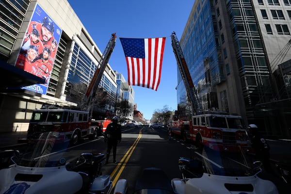 An American flag is flown outside of Capital One Arena before the Legacy on Ice event, a figure skating tribute to support the families and loved ones affected by the tragic January 29th aviation incident, Sunday, March 2, 2025, in Washington. (AP Photo/Nick Wass)