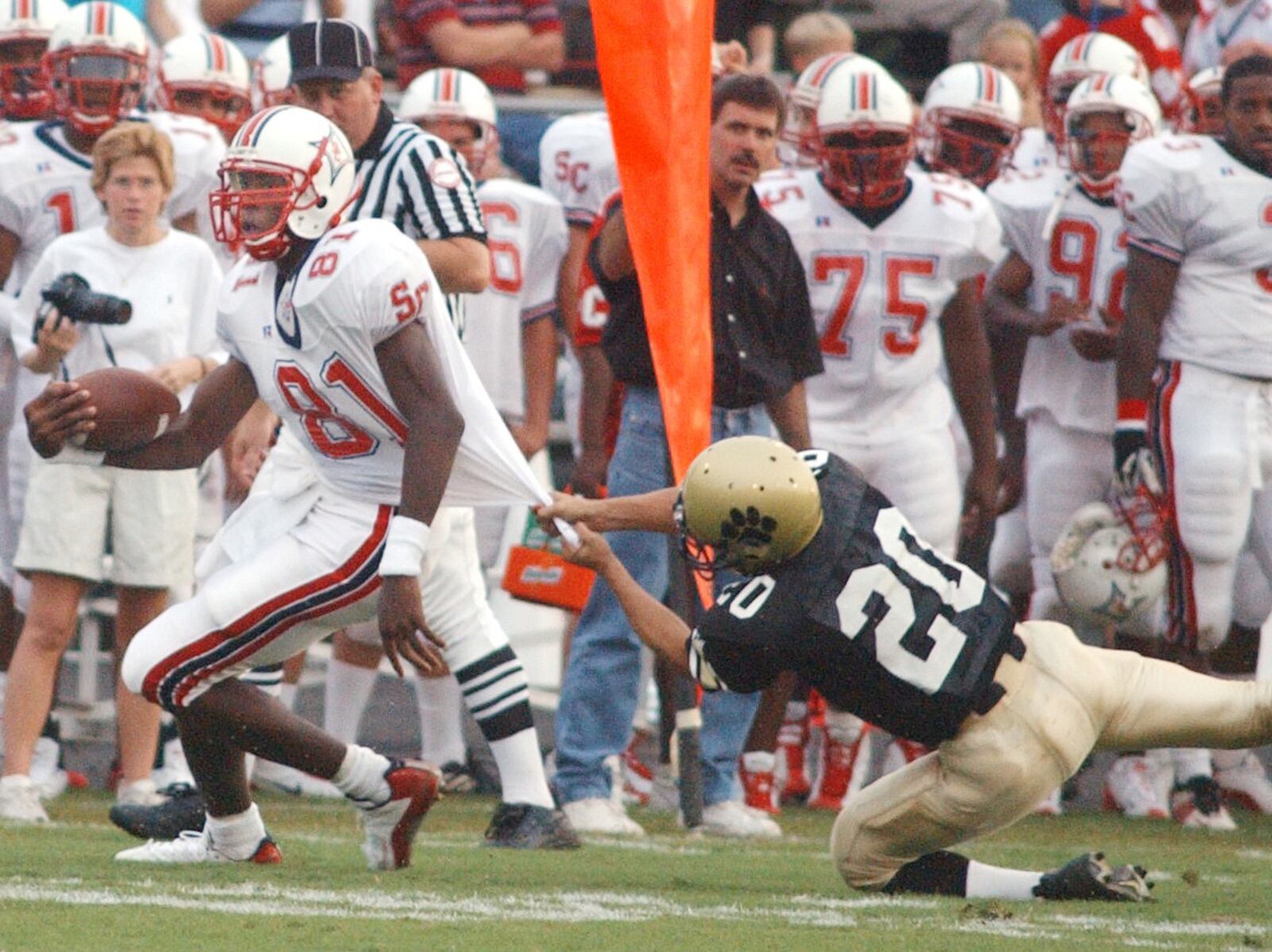 Sandy Creek receiver Calvin Johnson (81) gets away from Fayette County High's Jamil Merchant for a first down during a game Friday, Sept. 5, 2003, in Fayetteville.  (Marlene Karas/AJC)