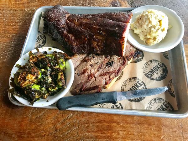 Smoke Ring offers various barbecue plates. Pictured is a plate with a half-rack of baby back ribs (top) and sliced brisket, and side dishes of potato salad and barbecue Brussels sprouts. LIGAYA FIGUERAS / LFIGUERAS@AJC.COM