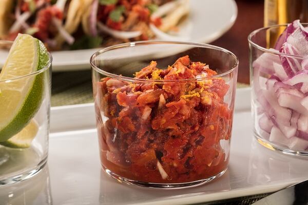 Canned fire-roasted tomatoes provide a quick base for a salsa that picks up the chipotle and orange flavors used for cooking the pork. Food styling by Mark Graham. 
(Zbigniew Bzdak/Chicago Tribune/TNS)