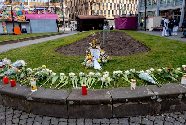 Flowers are laid in the city center of Mannheim, Germany, Tuesday, March 4, 2025, a day after a driver rammed a car into a crowd. (AP Photo/Michael Probst)