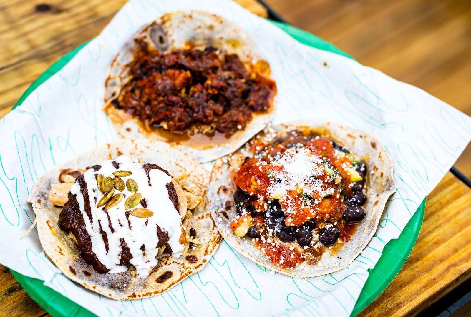 Three tacos from Supremo, clockwise from top: Al Pastor, Black Bean and Mole Poblano. CONTRIBUTED BY HENRI HOLLIS