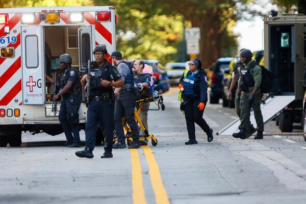 After an hourslong standoff, a suspect is taken into custody outside the Four Seasons Midtown on Oct. 29.