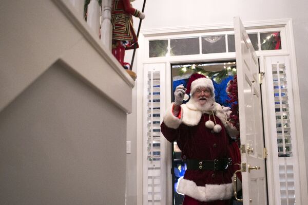 Judge T. Jackson Bedford makes his grand entrance as Santa Claus at a friend’s house Christmas party in Smyrna. CASEY SYKES / FOR THE ATLANTA JOURNAL-CONSTITUTION