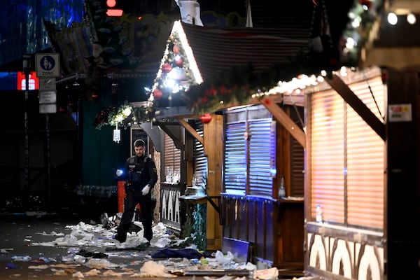 A policeman is seen at the Christmas market where an incident happened in Magdeburg, Germany, Friday Dec. 20, 2024. (Heiko Rebsch/dpa via AP)