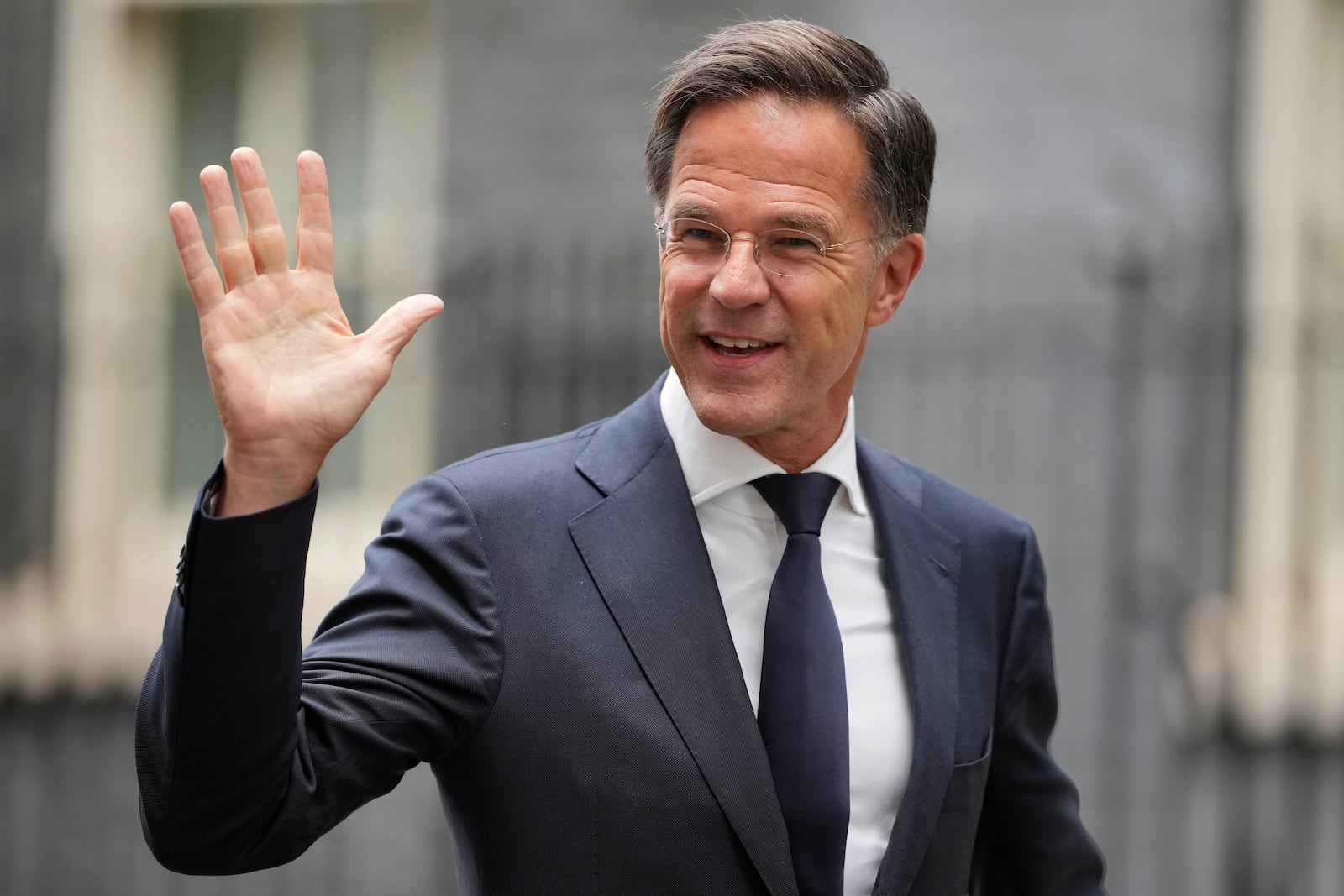 NATO Secretary General Mark Rutte waves to the media after a meeting with Britain's Prime Minister Keir Starmer and Ukrainian President Volodymyr Zelenskyy at 10 Downing Street in London, Thursday, Oct. 10, 2024.(AP Photo/Kin Cheung)