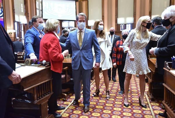 Gov. Brian Kemp and first lady Marty Kemp greet lawmakers as they leave the state House Chambers after he delivered the State of the State address. Kemp urged his fellow Republicans to move on from November's election, a message aimed at members of the party who entered the year on a mission to “assign blame, settle old scores, and relive and relitigate 2020.” (Hyosub Shin / Hyosub.Shin@ajc.com)