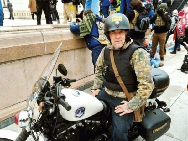 William Frederick Beals II of Ringgold, Ga., sits atop a U.S. Capitol Police motorcycle in a photo included as part of an FBI affidavit. He's scheduled to be sentenced today.