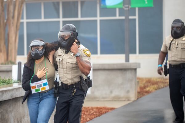 Gwinnett County law enforcement conducts an active drill exercise at the Gwinnett County Courthouse on Saturday, Dec 2, 2023 coordinating five law enforcement departments.  Local volunteers act as civilians in the exercise. (Jenni Girtman for The Atlanta Journal-Constitution)