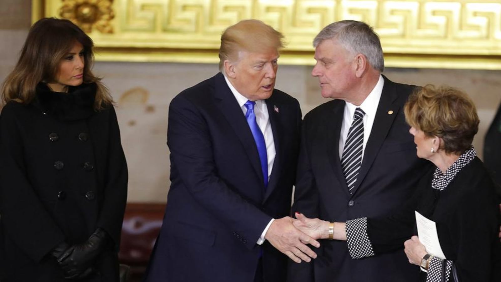 President Donald Trump and first lady Melania Trump, left, greet Franklin Graham and other family members of Rev. Billy Graham, as he lies in honor during a ceremony in the U.S. Capitol Rotunda, Wednesday, Feb. 28, 2018 in Washington. (Chip Somodevilla/Pool via AP)