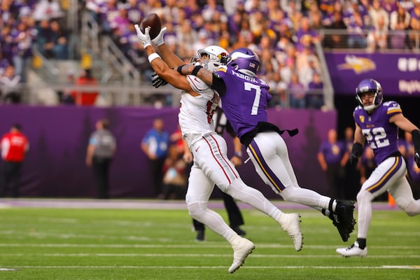 Arizona Cardinals wide receiver Michael Wilson (14) catches a pass over Minnesota Vikings cornerback Byron Murphy Jr. (7) during the first half of an NFL football game Sunday, Dec. 1, 2024, in Minneapolis. (AP Photo/Bruce Kluckhohn)