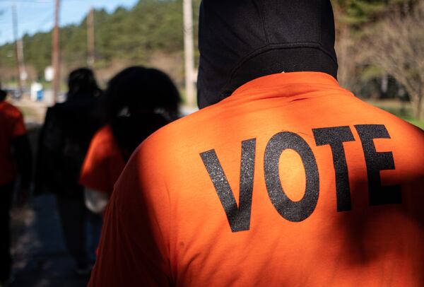 A group of canvassers with Georgia STAND-UP make their way through an East Point neighborhood distributing literature Wednesday morning, Dec. 2, 2020.  Ben Gray for The Atlanta Journal-Constitution