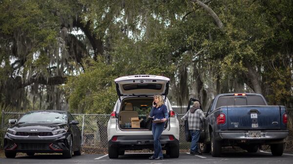 Melanie Pearson, center, an Emory University associate professor and community engagement expert, works out of the back of her SUV while contacting the day's participants in a pollution exposure study. Researchers are looking for traces of contaminants known to exist in the environment around Brunswick. (AJC Photo/Stephen B. Morton)