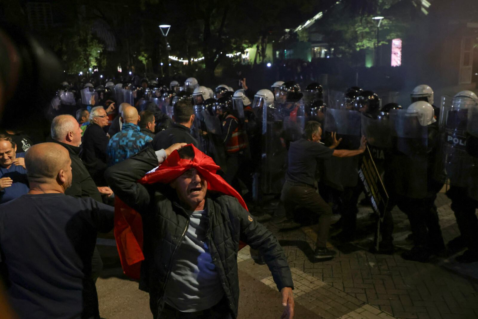 Opposition supporters scuffle with riot police during a anti-government rally, in Tirana, Albania, Monday, Oct. 7, 2024. (AP Photo/Hameraldi Agolli)