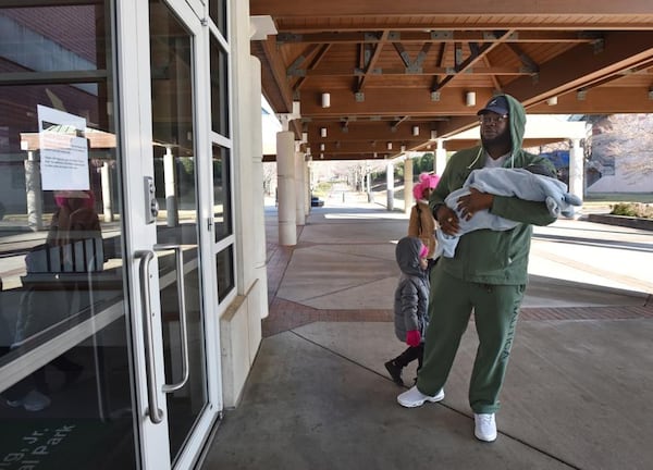 Javaris Green Sr. of St. Petersburg, Fla., holding his 3 months-old son Javaris Green Jr., can’t hide his disappointment as he finds out Martin Luther King Jr. National Historical Park is closed due to a government shutdown on Saturday, December 22, 2018. (Photo: HYOSUB SHIN / HSHIN@AJC.COM)