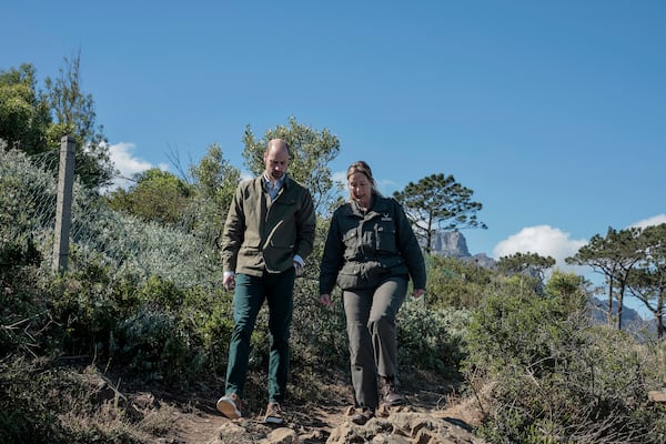 Britain's Prince William, left, talks with Park Manager for Table Mountain National Park Megan Taplin, right, while visiting Signal Hill in Cape Town, South Africa, Tuesday, Nov. 5, 2024. (Gianluigi Guercia/Pool via AP)