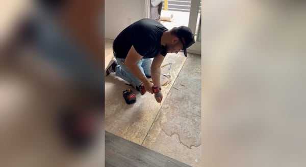 A worker is repairing the floor at the home of Tanya Wright following water damage as result of no flashing protection in the home, she said. Courtesy Tanya Wright