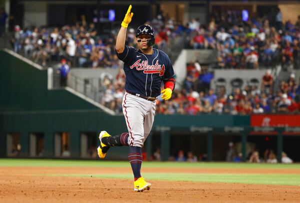 Atlanta Braves' William Contreras reacts after hitting a solo home run, his second of the day, against the Texas Rangers during the sixth inning of a baseball game April 29, 2022, in Arlington, Texas. (AP Photo/Ron Jenkins)