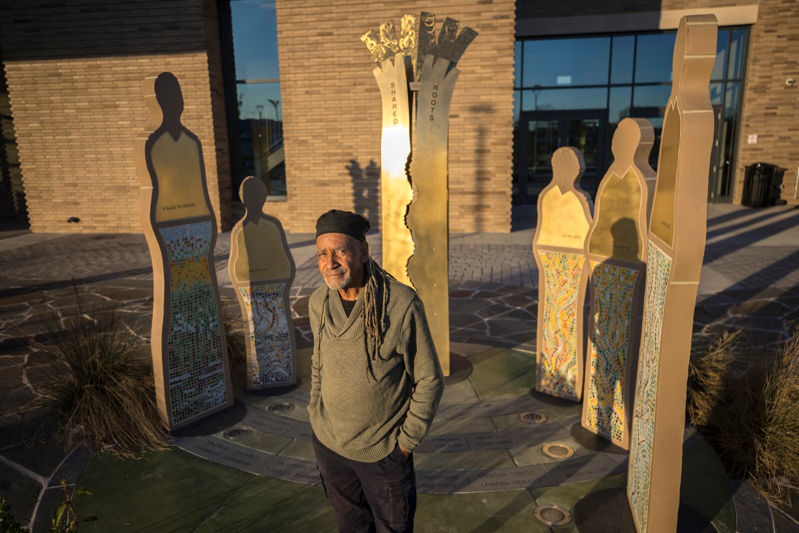 SAVANNAH, GA - FEBRUARY 07, 2024: World-renowned sculpture Jerome Meadows stands near his public piece titled, "Of Communities and the Land and the Trees that Bear Witness to Them", outside of the Enmarket Arena, Wednesday, Feb. 7, 2024, in Savannah, Ga. (AJC Photo/Stephen B. Morton)