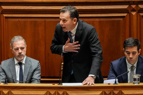 Portuguese Prime Minister Luis Montenegro, center, talks during a debate preceding a confidence motion vote at the Portuguese parliament in Lisbon, Tuesday, March 11, 2025. (AP Photo/Armando Franca)