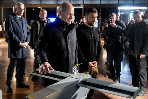 Ukraine's President Volodymyr Zelenskyy, right, and German Chancellor Olaf Scholz take a look at drones during Scholz's visit to Kyiv, Ukraine, Monday, Dec.2, 2024. (AP Photo/Efrem Lukatsky)