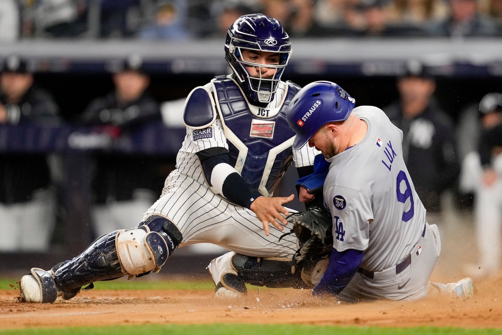 Los Angeles Dodgers' Gavin Lux scores past New York Yankees catcher Jose Trevino during the sixth inning in Game 3 of the baseball World Series, Monday, Oct. 28, 2024, in New York. (AP Photo/Ashley Landis)