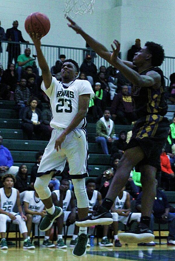  SWD's Demarion Johnson contests the shot of Arabia Mountain's Jordan Sterling. (Photo - Mark Brock)