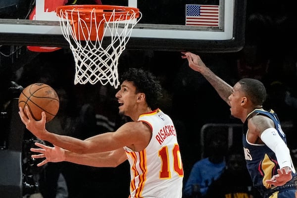 Atlanta Hawks forward Zaccharie Risacher (10) shoots against the New Orleans Pelicans during the first half of an NBA basketball game, Monday, Dec. 2, 2024, in Atlanta. (AP Photo/Mike Stewart)