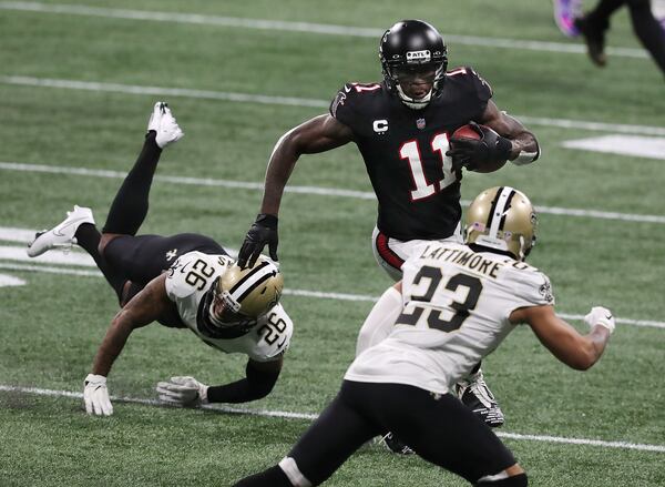 Falcons wide receiver Julio Jones makes a first-down reception against the New Orleans Saints during the first half Sunday, Dec. 6, 2020, at Mercedes-Benz Stadium in Atlanta.  (Curtis Compton / Curtis.Compton@ajc.com)