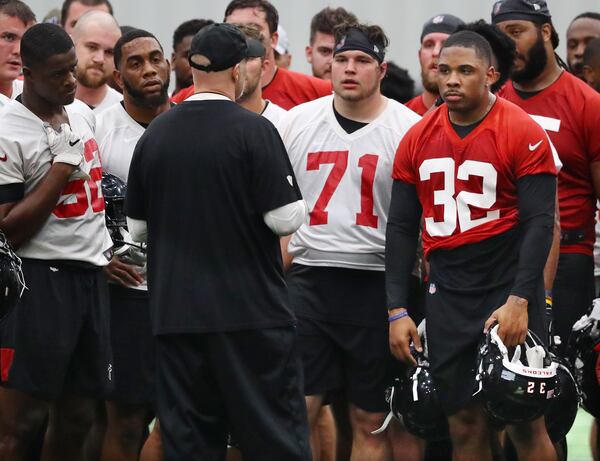 Falcons running back Qadree Ollison (32) listens as head coach Dan Quinn talks during the second day of rookie minicamp on Saturday, May 11, 2019, in Flowery Branch.  Curtis Compton/ccompton@ajc.com