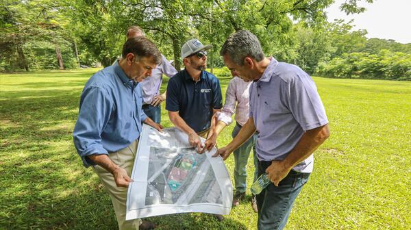 Rawson Haverty, a partner with Forever Young, and Dave Geist, the developer of the property, examine a rendering of the proposed aquaponics farm on the Clayton County site. (Courtesy photo)