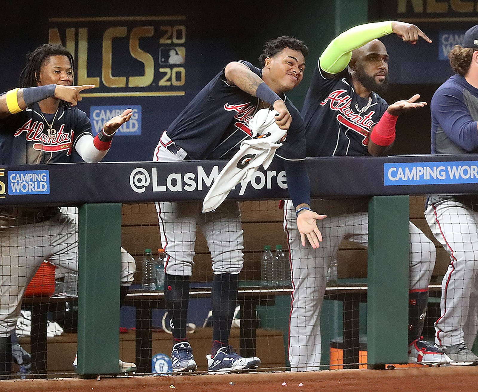 Braves (from left) Ronald Acuna, Cristian Pache, and Marcell Ozuna mix it up from the dugout in reaction to Ozzie Albies' solo homer in the 8th inning.   “Curtis Compton / Curtis.Compton@ajc.com”