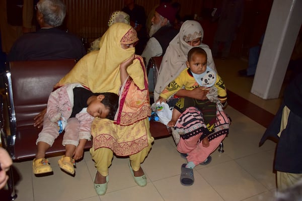 Passengers rescued by security forces from a passenger train attacked by insurgents rest upon their arrival at a railway station in Quetta, Pakistan, Wednesday, March 12, 2025. (AP Photo/Arshad Butt)