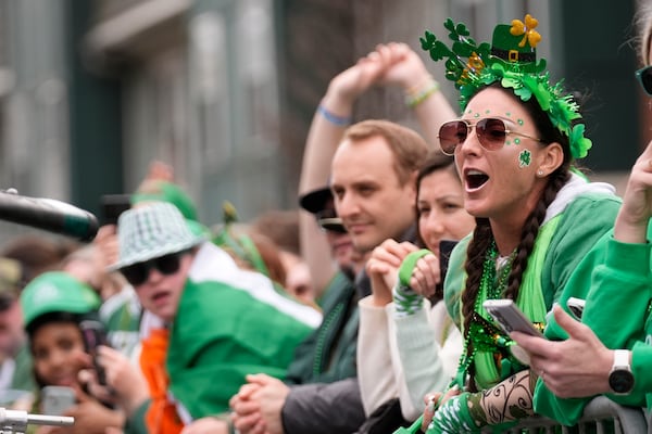 Spectators cheer during the St. Patrick's Day parade, Sunday, March 16, 2025, in Boston, Mass. (AP Photo/Robert F. Bukaty)