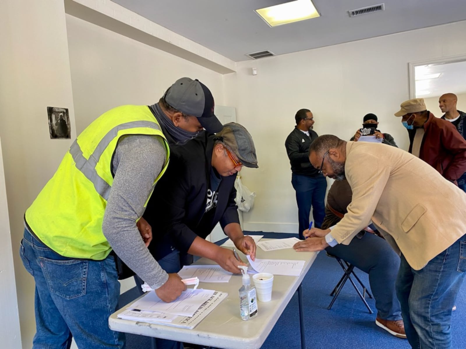 Najee Dorsey looks over documents as he prepares to sign the contract with Star construction to build the new facility in East Point.