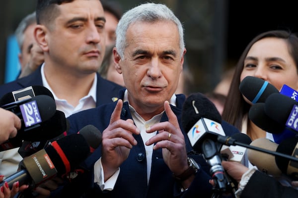 Calin Georgescu, the winner of the first round of presidential elections, later annulled by the Constitutional Court, speaks to media after registering his new bid for the country's presidency outside Romania's Electoral Authority, in Bucharest, Romania, Friday, March 7, 2025. (AP Photo/Andreea Alexandru)