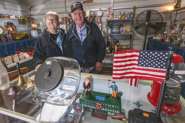 Geri Elrod (Left) and her husband Weyman at their booth at Sweeties Flea Market, located off U.S. 19/41 in Hampton. Steve Schaefer/steve.schaefer@ajc.com