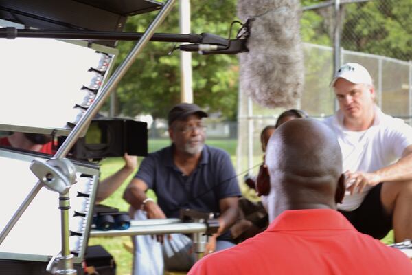 Filmmakers Sam Pollard (left) and Douglas Blackmon (right) interview Brandon Taylor (middle), a Leland resident, while filming "The Harvest."