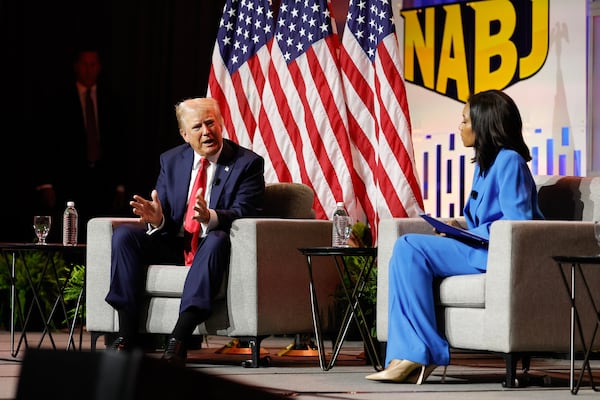 Former President Donald Trump answers questions as moderator Rachel Scott listens during a gathering of the National Association of Black Journalists in Chicago on Wednesday.