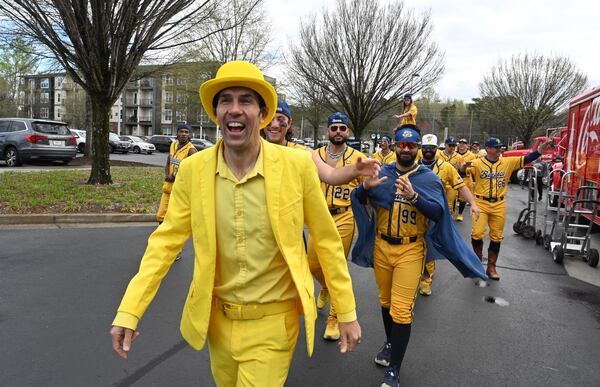 Savannah Bananas owner Jesse Cole and team members march thru the parking lot as they entertain fans before their first of three-game series at Coolray Field, Saturday, March 23, 2024, in Lawrenceville. The Savannah Bananas’ visit is their first to the Atlanta area since their founding in 2016. The team is based in their namesake Georgia city and plays 30-plus games a year at Historic Grayson Stadium, a century-old ballpark on Savannah’s eastside. (Hyosub Shin / Hyosub.Shin@ajc.com)