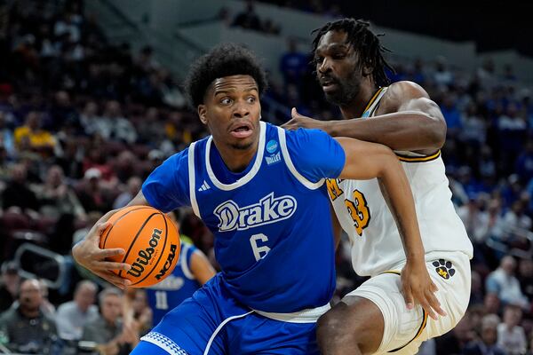 Drake guard Tavion Banks (6) drives past Missouri center Josh Gray (33) during the first half of the first round of the NCAA college basketball tournament, Thursday, March 20, 2025, in Wichita, Kan. (AP Photo/Charlie Riedel)