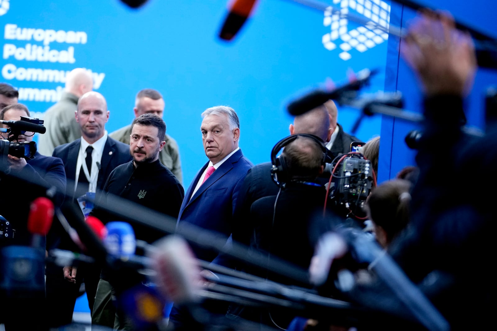 Ukraine's President Volodymyr Zelenskyy, center left, speaks with Hungary's Prime Minister Viktor Orban, center right, as he arrives for the European Political Community (EPC) Summit at the Puskas Arena in Budapest, Hungary, Thursday, Nov. 7, 2024. (AP Photo/Petr Josek)