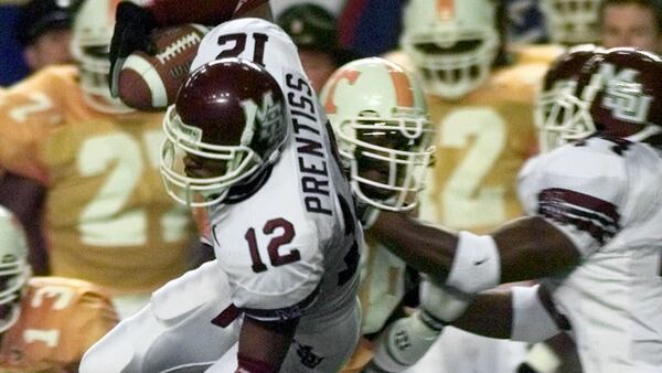 Mississippi State's Kevin Prentiss (12) takes it to the 30 on a kickoff return as he is tripped up by Tennessee's Dominique Stevenson (28) in the 1998 SEC Championship Game in Atlanta. 