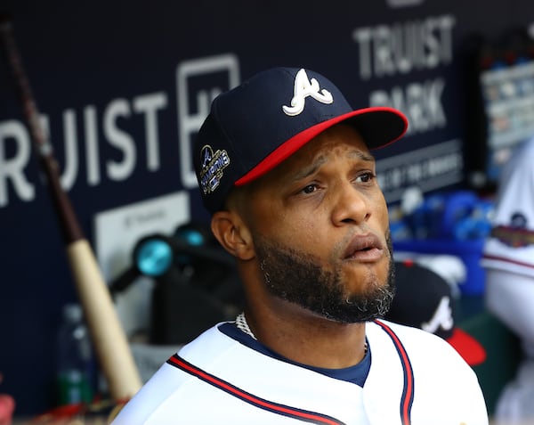 Robinson Cano watches from the dugout against the New York Mets during the first inning in a MLB baseball game on Monday, July 11, 2022, in Atlanta.  “Curtis Compton / Curtis Compton@ajc.com”