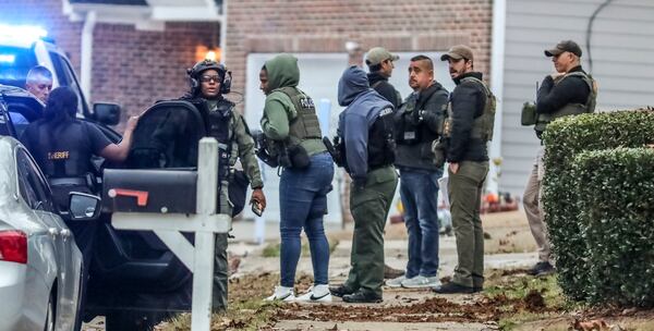 FBI agents and Fulton County deputies in full SWAT attire focused on a house on Wickum Road.

