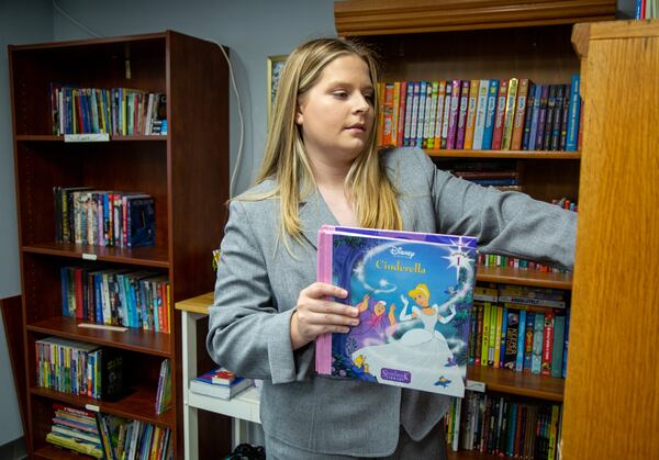 Josie Dunlap checks the supply of books in the resource room at Eastside Mosaic Church in Marietta. PHIL SKINNER FOR THE ATLANTA JOURNAL-CONSTITUTION.