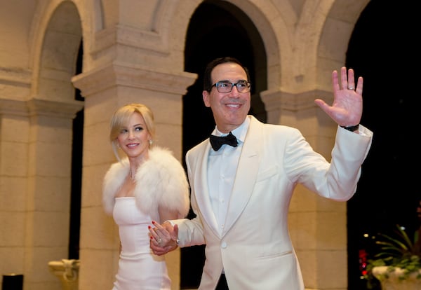 Treasury Secretary Steven Mnuchin and his wife, Louise Linton, arrive for a New Year's Eve gala with President Donald Trump at the Mar-a-Lago club in Palm Beach, Fla., Dec. 31, 2017. (Greg Lovett / The Palm Beach Post)