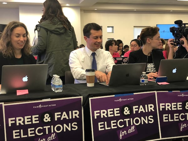 Pete Buttigieg, mayor of South Bend, Ind., taps as quickly as he can on a laptop that sent dozens of text messages to voters whose registrations could be canceled because they haven't participated in recent elections on Thursday, Nov. 21, 2019. MARK NIESSE / MARK.NIESSE@AJC.COM