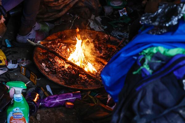 Views of a fire burning under a tent at a  homeless encampment near Cheshire Bridge Road in Atlanta shown on Friday, December 29, 2023. (Natrice Miller/ Natrice.miller@ajc.com)