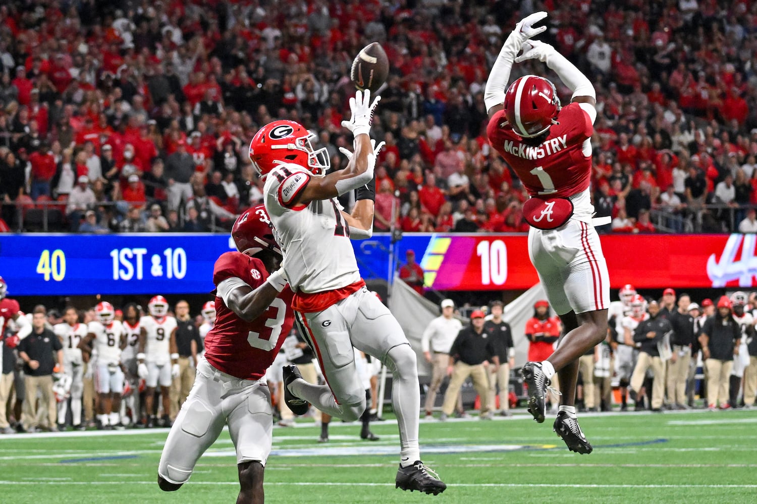 Alabama Crimson Tide defensive backs Kool-Aid McKinstry (1) and Terrion Arnold (3) block an attempted pass to Georgia Bulldogs wide receiver Arian Smith (11) during the first half of the SEC Championship football game at the Mercedes-Benz Stadium in Atlanta, on Saturday, December 2, 2023. (Hyosub Shin / Hyosub.Shin@ajc.com)